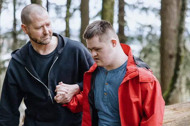 Man caring for a boy with Down Syndrome