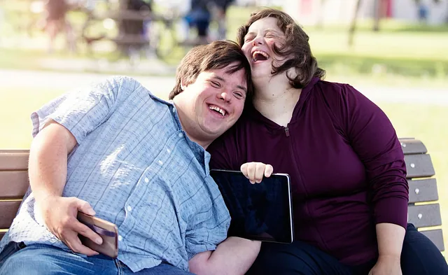 Two people with Down Syndrome laughing
