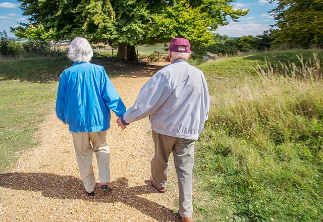 Two old people holding hands